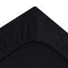A close-up view of the corner of a black fitted sheet. Produktbild-Vorschau