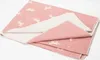 A folded pink blanket with a white unicorn pattern is shown on a white background. Náhľad obrázku produktu