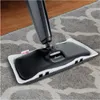 A steam mop head with a white pad is shown cleaning a patterned gray carpet next to a wooden floor. Produktbild-Vorschau