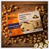 Kandylas Halva mit Pistazien 200 g Verpackung auf Holzuntergrund mit Pistazien Produktbild-Vorschau