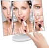 A woman applying lipstick in front of a tri-fold makeup mirror with LED lights. Produktbild-Vorschau