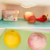 Two images showing refrigerator shelves with food items and liners. Produktbild-Vorschau