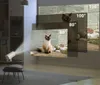 A white projector is projecting an image of a cat onto a wall, with multiple projected image sizes indicated by text overlays. Náhled obrázku produktu