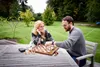 A couple playing chess on a wooden table outdoors. Podgląd zdjęcia produktu