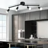 A modern kitchen with sleek gray cabinets and a black track light fixture. Produktbild-Vorschau