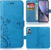 A collage of images showing a blue flip phone case with a floral and butterfly design, including a view of the inside with card slots and a simulated phone screen. Produktbild-Vorschau