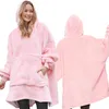 A woman wearing a pink hoodie blanket, shown from the front and back. Produktbild-Vorschau