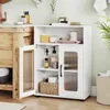 A white bathroom storage cabinet with two doors and shelves, placed next to a wooden vanity and a sink. Various bathroom items are displayed on and inside the cabinet. Anteprima dell’immagine prodotto