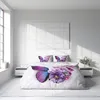 A bedroom scene with a bed featuring a butterfly-themed duvet cover and pillows. Produktbild-Vorschau