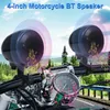 Motorcycle handlebars with speakers and a speedometer, set against a scenic background of trees and a road. Náhled obrázku produktu