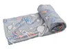 A rolled-up blanket with a space-themed pattern. Náhled obrázku produktu