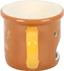 A close-up side view of a ceramic oil burner shaped like a mug. Voir les images du produit