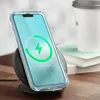 A clear phone case with a charging indicator on the screen, placed on a wireless charger next to a coffee cup and books. Podgląd zdjęcia produktu