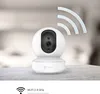 A white smart camera with Wi-Fi signal waves emanating from it, placed on a textured surface. Voir les images du produit