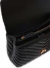 A close-up view of the interior of a black quilted handbag. Voir les images du produit