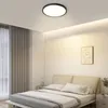 A bedroom with a bed, curtains, and a ceiling light. Voir les images du produit