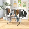 A drying rack with clothes is set up in a room with artwork on the wall. Anteprima dell’immagine prodotto