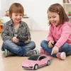 Two children playing with a remote-controlled car on the floor. Náhled obrázku produktu