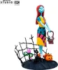 A collectible figure of Sally from The Nightmare Before Christmas, standing on a themed base with a cat, pumpkins, and a plant. Podgląd zdjęcia produktu