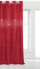 A red curtain with glitter accents hangs in front of a window. Produktbild-Vorschau