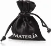 A black drawstring pouch with the brand name 'MATERIA' printed in white. Produktbild-Vorschau