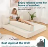 A woman is relaxing on a sofa bed, using a tablet. The sofa is in a living room setting. Produktbild-Vorschau
