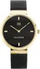 A close-up studio shot of a Tommy Hilfiger women's watch with a black dial and gold-tone case and mesh strap. Produktbild-Vorschau