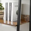 A close-up view of books on a shelf, with a measurement indicator. Produktbild-Vorschau
