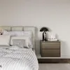 A bedroom scene with a bed and a nightstand. Náhľad obrázku produktu
