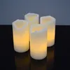 Four LED candles are arranged on a black surface against a gray background. Produktbild-Vorschau