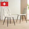 Two beige upholstered dining chairs with black metal legs are shown in a room with light-colored walls and wooden paneling. Produktbild-Vorschau