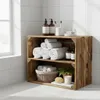 A wooden crate shelf unit filled with towels, soap dispensers, toothbrushes, and a plant in a bathroom setting. Náhled obrázku produktu