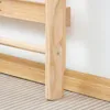 Close-up of the wooden climbing frame attached to a wall, showing the base and a horizontal bar. Náhľad obrázku produktu
