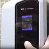 A person's finger is touching the screen of an EV charger. Náhled obrázku produktu