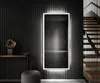 A modern interior with a large, illuminated mirror on a ribbed wall, next to a staircase. Produktbild-Vorschau