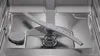 Close-up view of the interior of a dishwasher, focusing on the spray arm and filter system. Produktbild-Vorschau