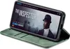 A smartphone in a green flip case is displayed on a white background, showing a movie streaming interface on its screen. Produktbild-Vorschau