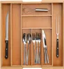 A bamboo cutlery organizer with various utensils placed inside. Podgląd zdjęcia produktu