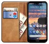 A book-style phone case with a smartphone inside, showing cards and cash in the case. Anteprima dell’immagine prodotto