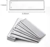 A stack of blank metal license plates or tags with dimensions indicated. Produktbild-Vorschau