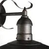 A close-up view of a rustic-style outdoor wall lamp, focusing on the metallic details and construction. Anteprima dell’immagine prodotto