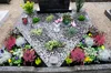 A grave decorated with gravel and plants. Produktbild-Vorschau