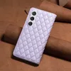 A light purple quilted phone case is placed on a brown leather background. Produktbild-Vorschau