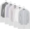 Multiple suits and jackets hanging in protective garment bags. Produktbild-Vorschau