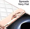 Close-up of a white phone case with a rose gold ring holder and diamond accents. Produktbild-Vorschau