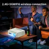 Two men playing video games in a living room with a projector on a coffee table. Náhled obrázku produktu
