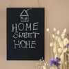A chalkboard sign with chalk writing and a drawing of a house. Náhled obrázku produktu