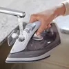A hand is filling a Philips iron with water from a faucet. Voir les images du produit