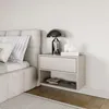 A bedside table with a drawer and shelf next to a bed. Voir les images du produit