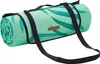 A rolled-up picnic blanket with a tropical leaf pattern and a carrying strap. Produktbild-Vorschau